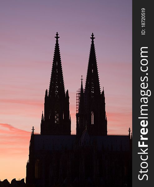 The spires of Cologne cathedral silhouetted against an October sunset