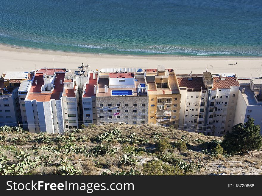 Buildings by beach and sea, Alicante, Spain.