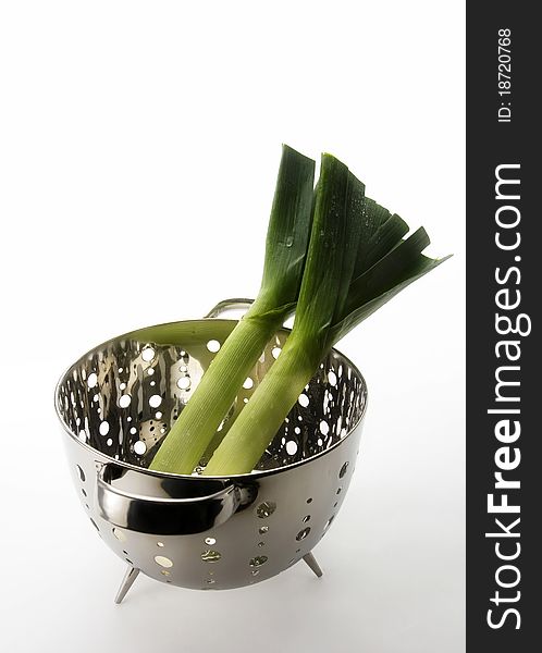 Two healthy, nutritious looking leeks in a collander ready for cooking