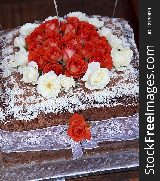 Yummy cake decorated with white and red flowers