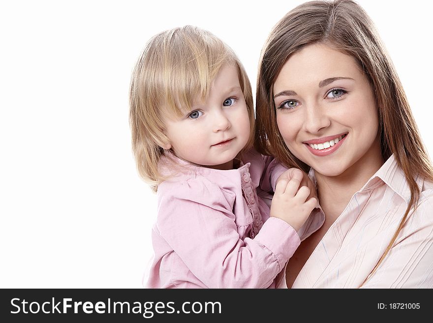 Young mother with her daughter in her arms on a white background. Young mother with her daughter in her arms on a white background