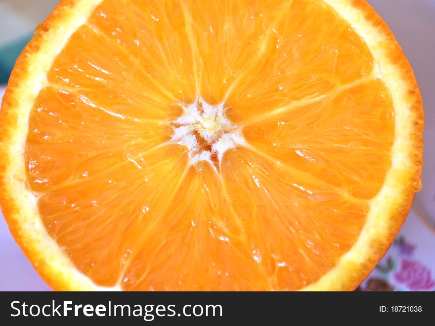 Transverse cut of orange on the plate, macro