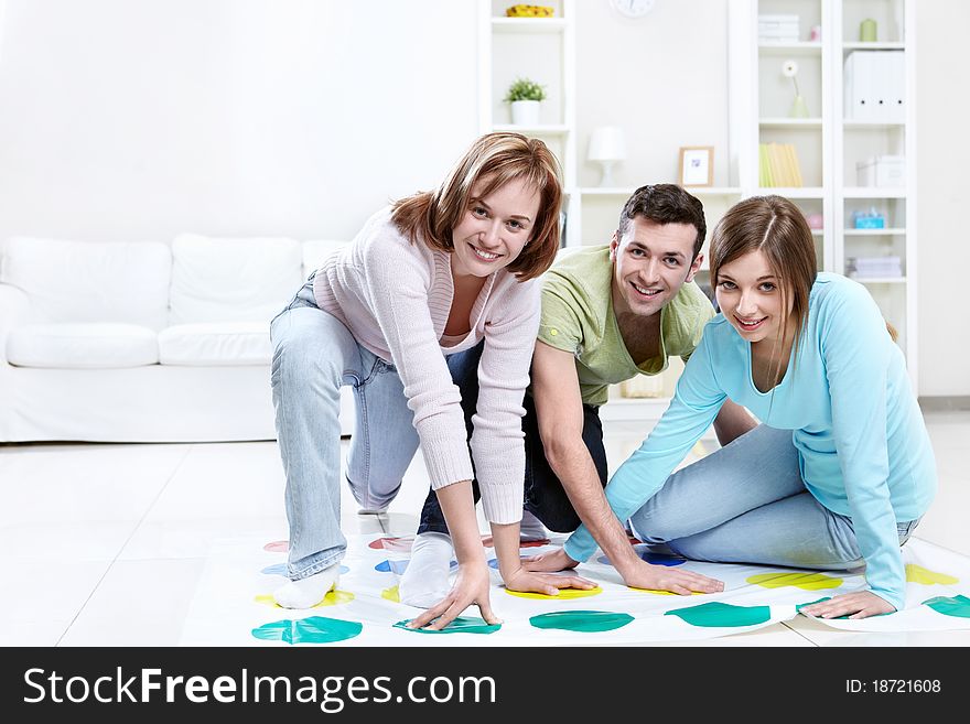 Attractive young people play Twister. Attractive young people play Twister