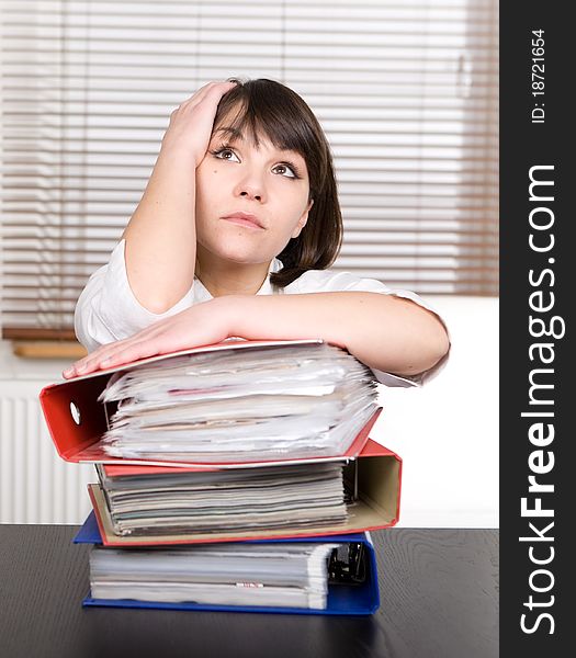 Young adult over-worked woman at desk