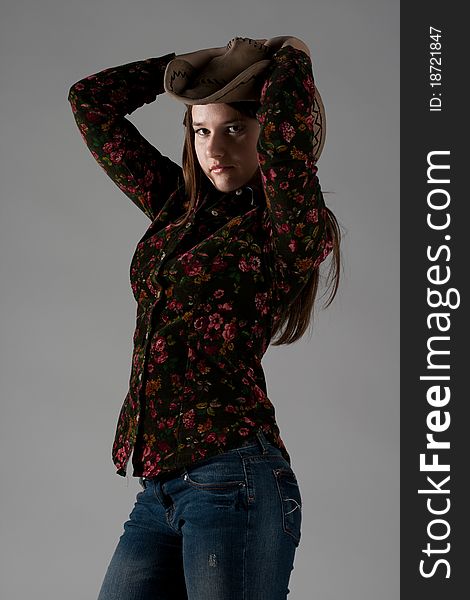 Attractive cowgirl portrait on white background