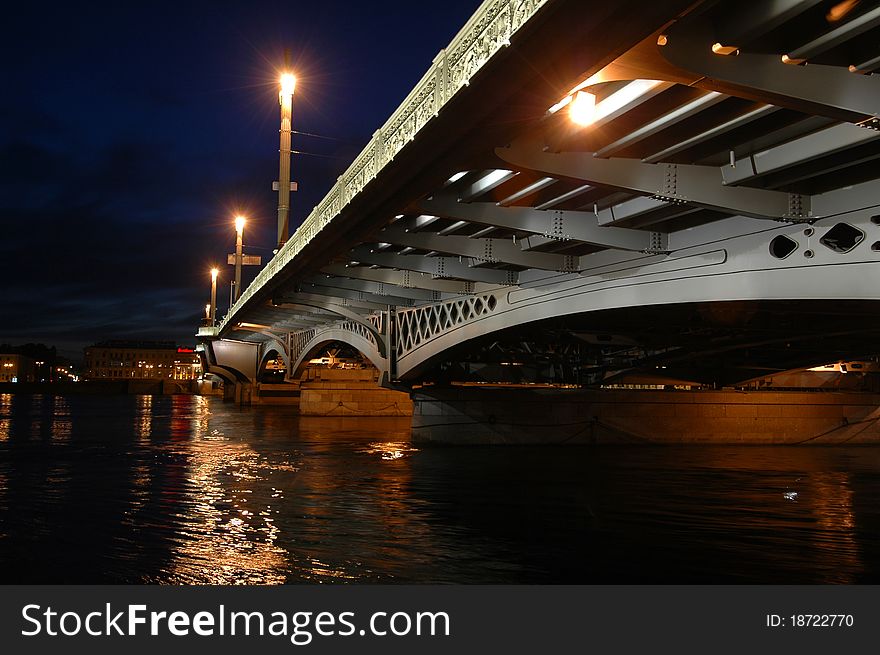 City bridge over the river. Night light.