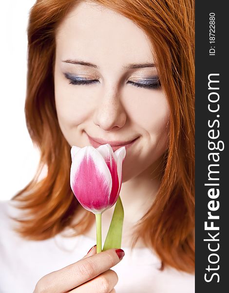 Beautiful red-haired girl with tulips. Studio shot.