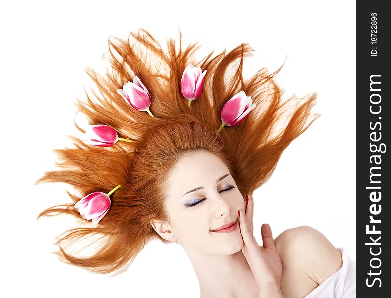 Beautiful red-haired girl with tulips. Studio shot.