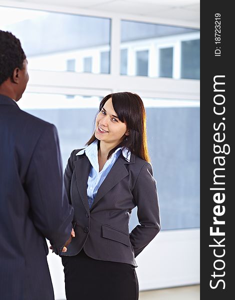 African American business man and caucasian woman handshake at office building