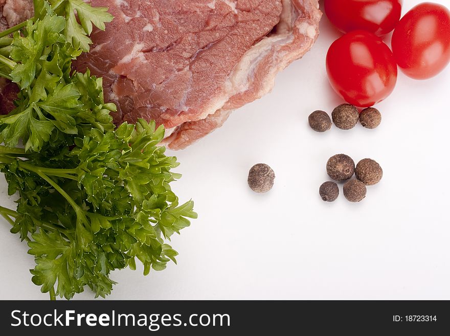 A large piece of raw meat on a white background.