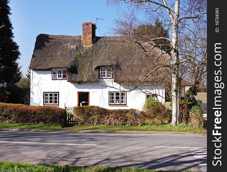 Thatched Village Cottage Next To A Road