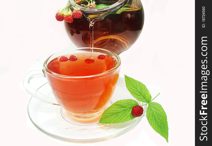 Fruit red tea with ripe raspberry pouring
