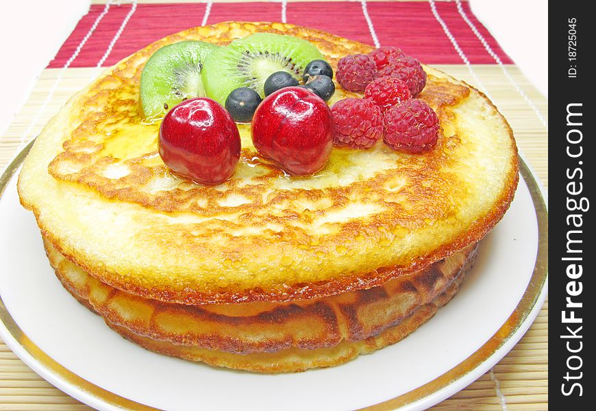 Sweet pancakes with raspberry kiwi and cherry in syrup jam. Sweet pancakes with raspberry kiwi and cherry in syrup jam