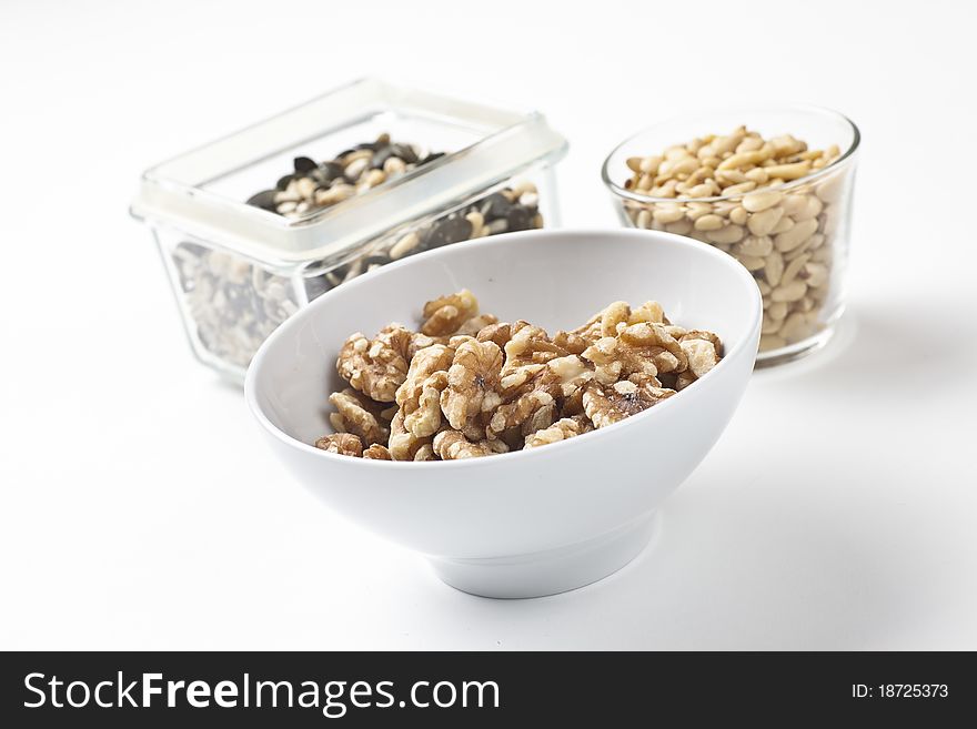 Mix of different nuts and seeds arranged on a white table. Mix of different nuts and seeds arranged on a white table