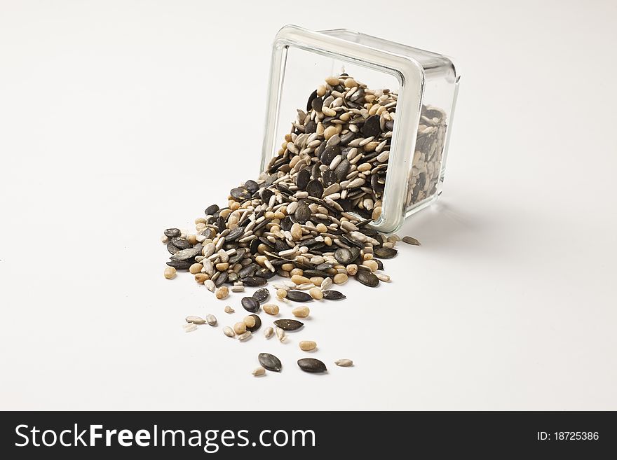 Mix of different nuts and seeds arranged on a white table. Mix of different nuts and seeds arranged on a white table