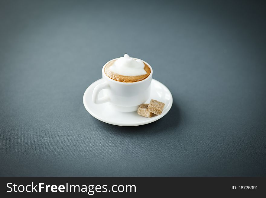 Close up of a small cup of cappucciono with nice crï¿½ma on top. Close up of a small cup of cappucciono with nice crï¿½ma on top