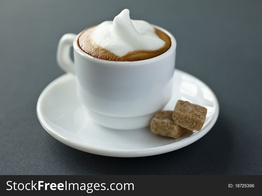 Close up of a small cup of cappucciono with nice cr�ma on top. Close up of a small cup of cappucciono with nice cr�ma on top