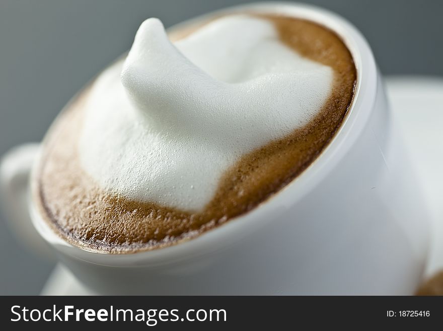 Close up of a small cup of cappucciono with nice cr�ma on top. Close up of a small cup of cappucciono with nice cr�ma on top