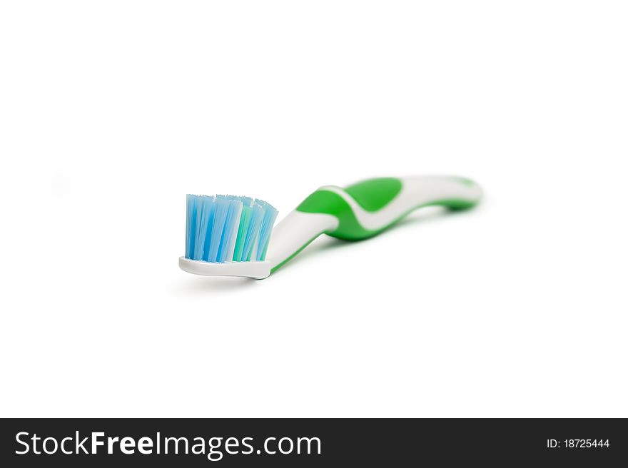 Green toothbrush isolated over white