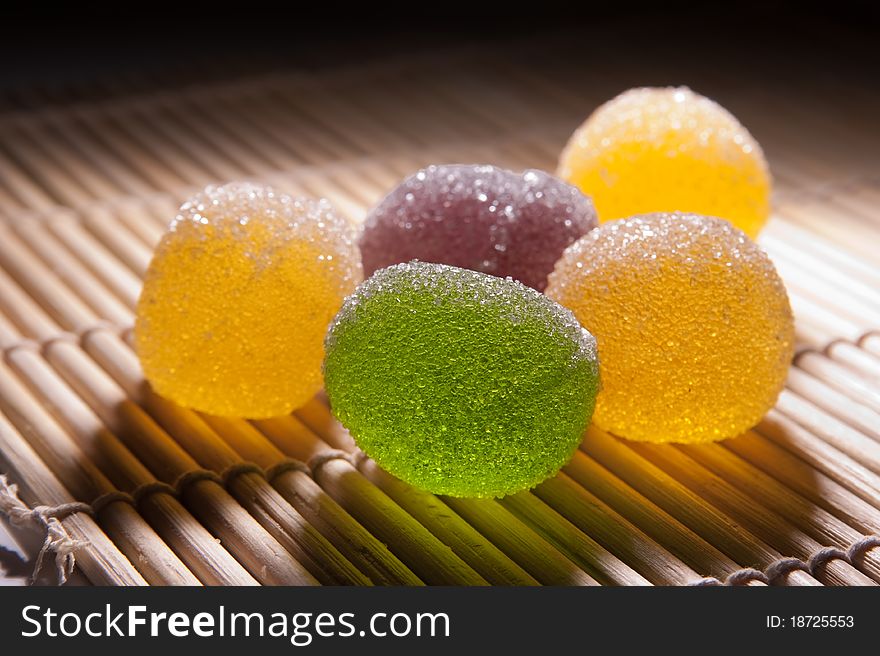 Jujube in sugar. Backlight. Focus is pointed on a green piece