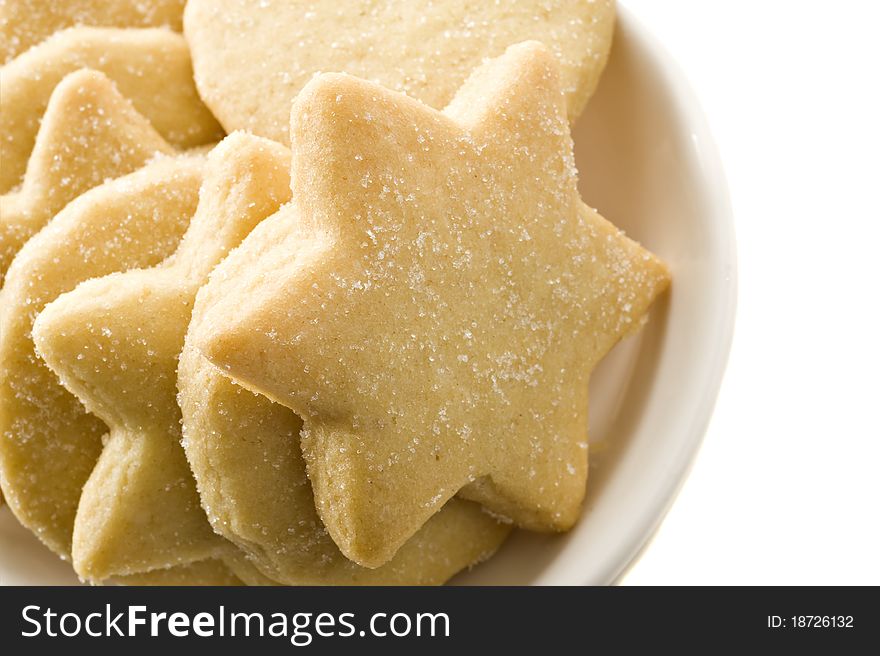 Star shaped homemade cookies in a white plate on a white background