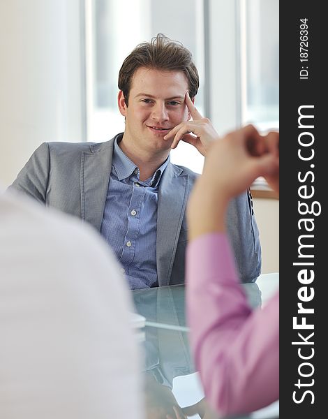 Young business man alone in conference room