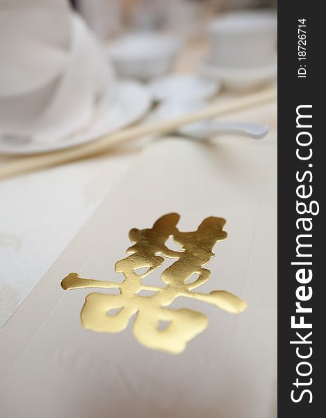 A table setting of typical chinese wedding with love in golden characters. A table setting of typical chinese wedding with love in golden characters.