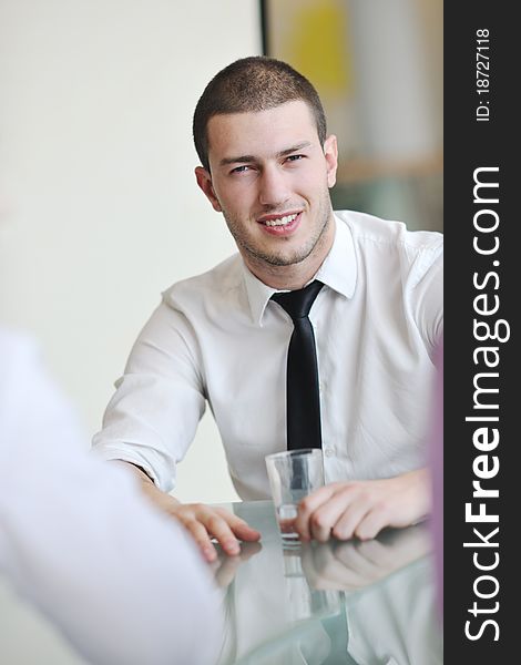 Young business man lawyer with laptop alone in big bright conference room. Young business man lawyer with laptop alone in big bright conference room