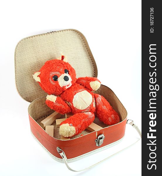 A small old suitcase and worn teddy bear on white. A small old suitcase and worn teddy bear on white