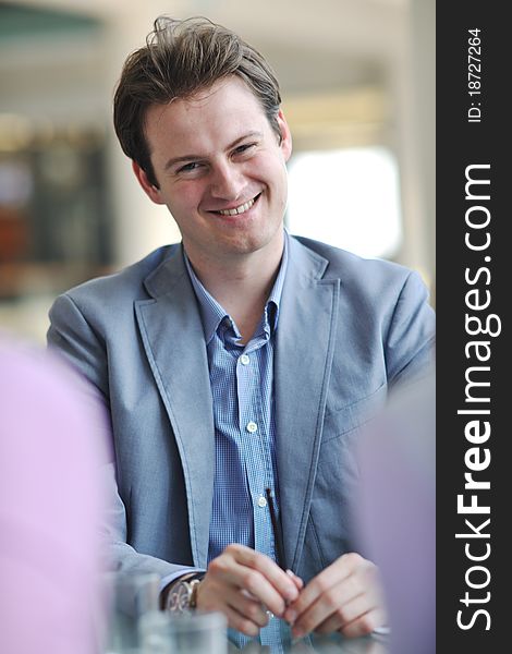 Young business man alone in conference room