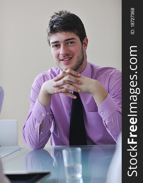 Young business man lawyer with laptop alone in big bright conference room. Young business man lawyer with laptop alone in big bright conference room