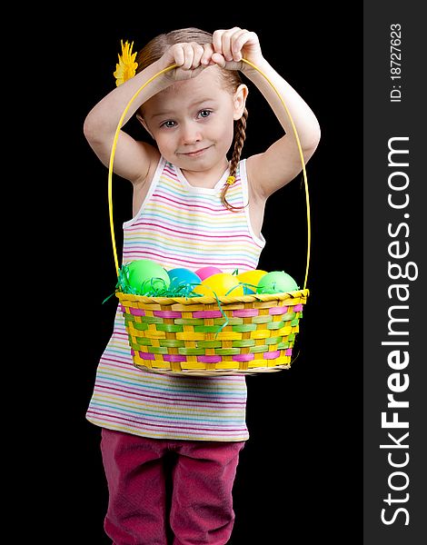 A cute girl holding up her colorful easter basket. A cute girl holding up her colorful easter basket.