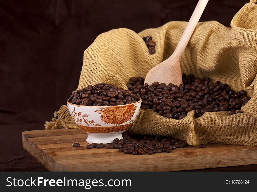 Close view of a bunch of roasted beans of coffee inside a bowl. Close view of a bunch of roasted beans of coffee inside a bowl.