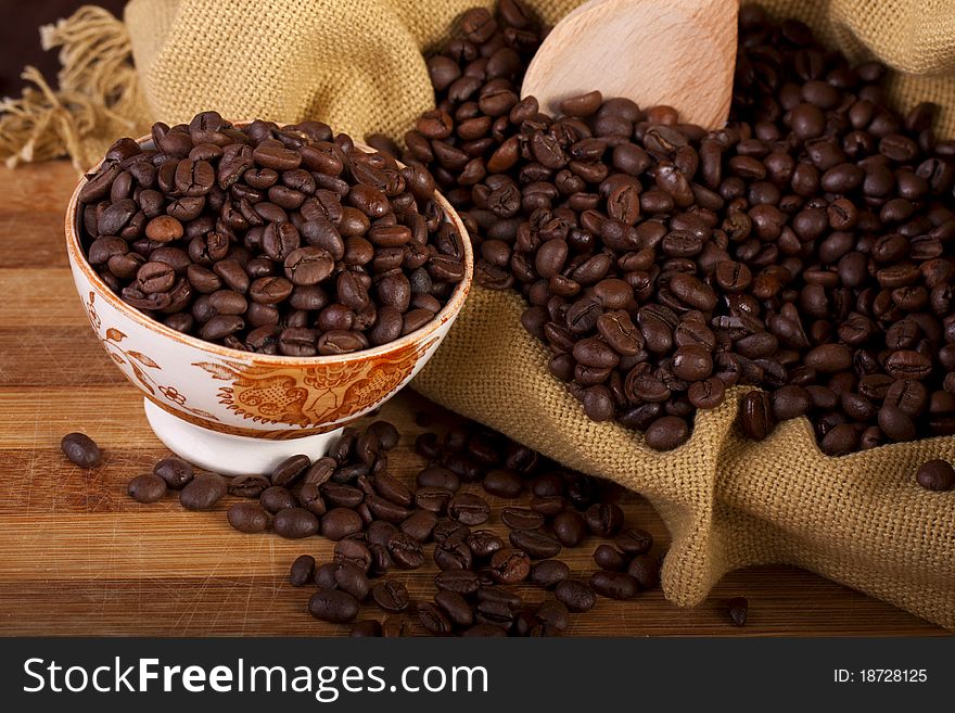 Close view of a bunch of roasted beans of coffee inside a bowl. Close view of a bunch of roasted beans of coffee inside a bowl.