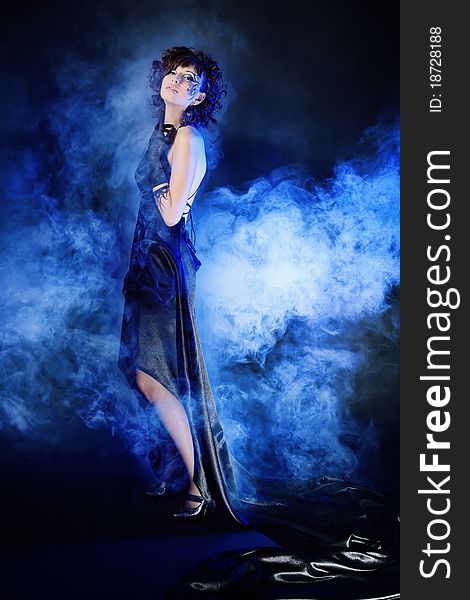 Beautiful fashionable woman in black dress. Studio shot.