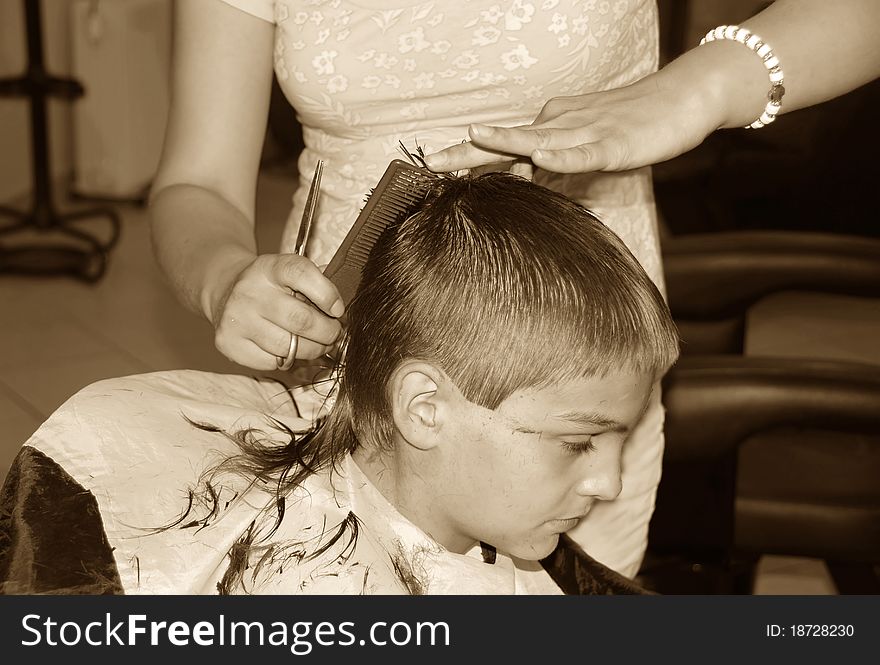 Caucasian boy getting a haircut sepia tones. Caucasian boy getting a haircut sepia tones