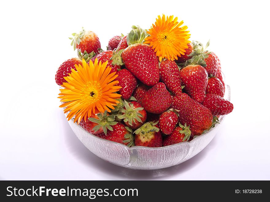 View of a bowl filled with strawberries isolated on a white background. View of a bowl filled with strawberries isolated on a white background.