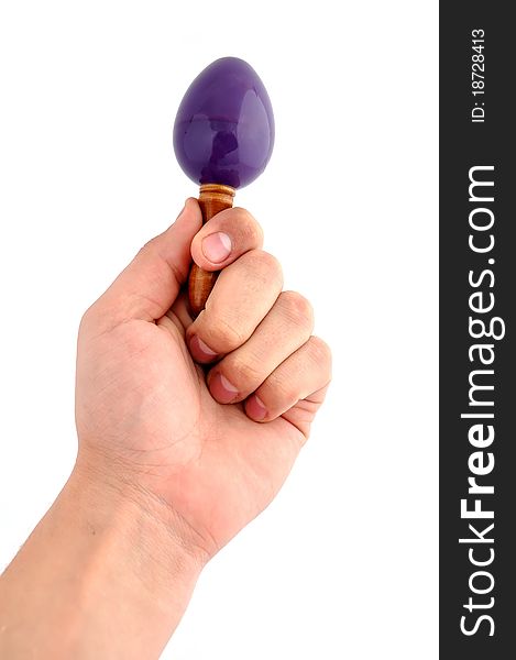Maraca in hand on a white background
