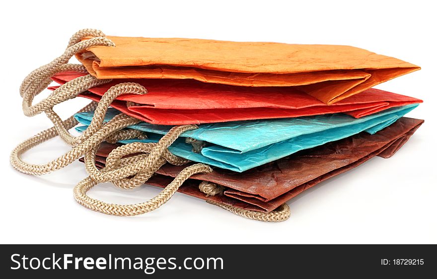 Four color paper bags isolated on the white background