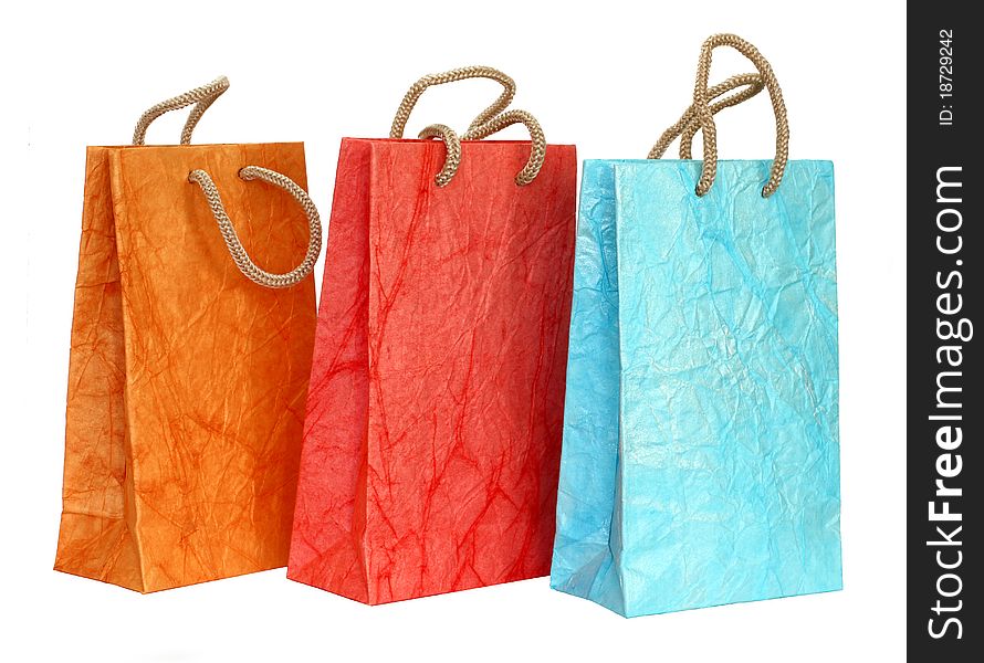 Three color paper bags isolated on the white background