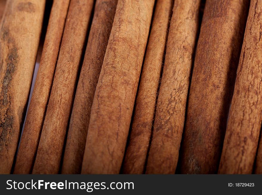 View of a bunch of cinnamon spice quills isolated on a white background. View of a bunch of cinnamon spice quills isolated on a white background.