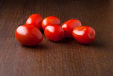 Several Cherry Tomatoes On A Wood Table Royalty Free Stock Photo
