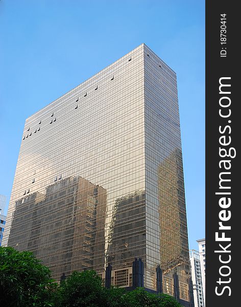 Golden office building with blue sky background in guangzhou city.