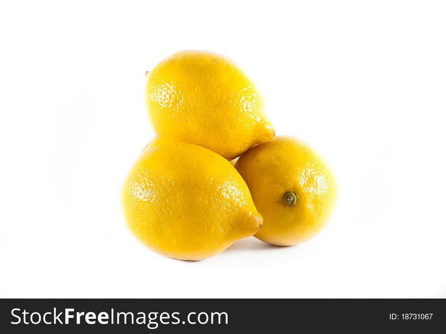 Four fresh yellow lemons stacked on a white isolated background. Four fresh yellow lemons stacked on a white isolated background.
