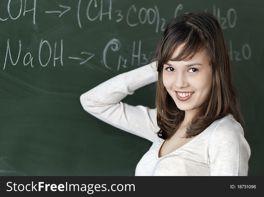 The girl sits at a school desk at a lesson of chemistry and understands nothing. The girl sits at a school desk at a lesson of chemistry and understands nothing