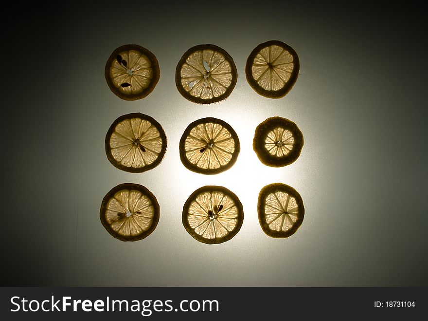 Nine lemon slices in a sqaure lit from behind. Nine lemon slices in a sqaure lit from behind.