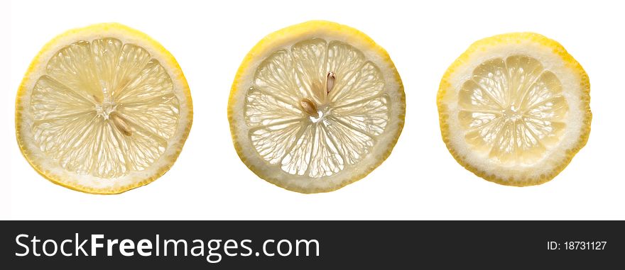 Three fresh yellow lemons slices on a white isolated background. Three fresh yellow lemons slices on a white isolated background.