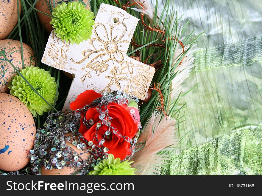 Easter wreath with eggs and decorations on green cloth