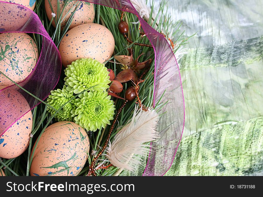 Easter wreath with eggs and decorations on green cloth