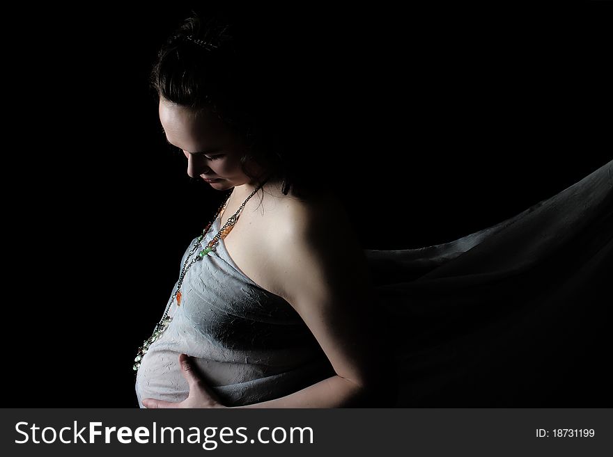 Beautiful pregnant lady against a black background. Beautiful pregnant lady against a black background